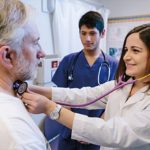 Medical students giving an examination. Read about Gifts of Real Estate