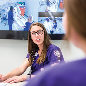 Students sitting in front of a screen looking at another student. Read about Donor-Advised Funds