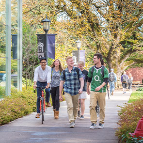 Group of students walking and biking down path. Read about Closely Held Business Stock Group of students walking and biking down path. Read about Closely Held Business Stock