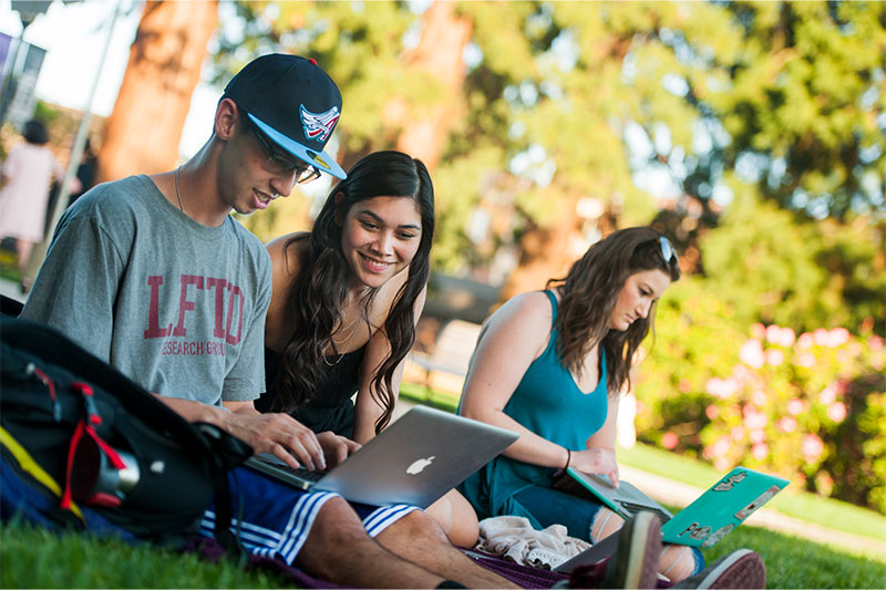 a man is pointing to the writing on the ceiling of the T Room